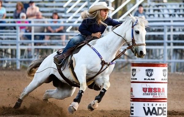 Woman barrel racing on her horse