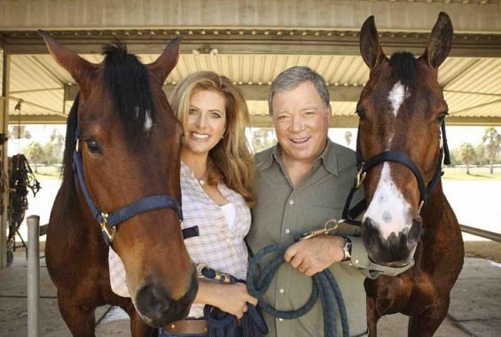 William and Elizabeth Shatner holding horses