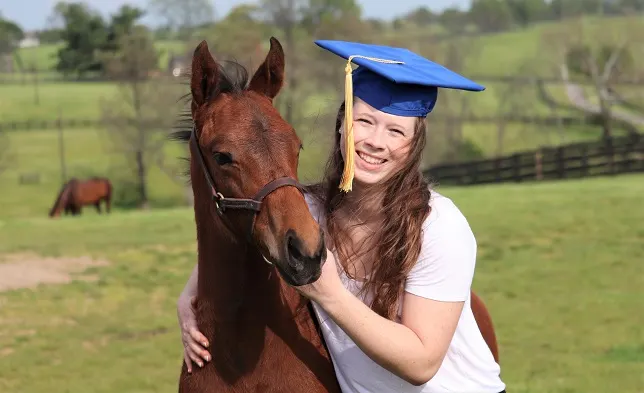 Student at the University of Kentucky hugging a horse