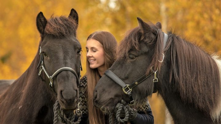 Is horse riding cruel? A girl holding two horses