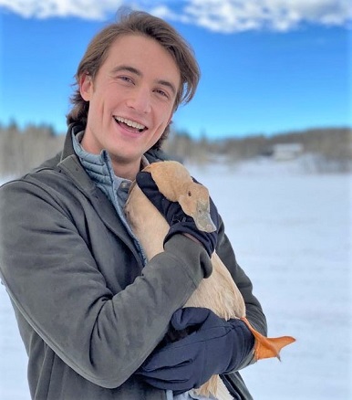 Actor Jordan Burtchett holding a duck