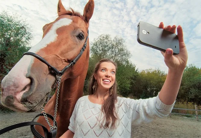Woman taking of herself with her horse
