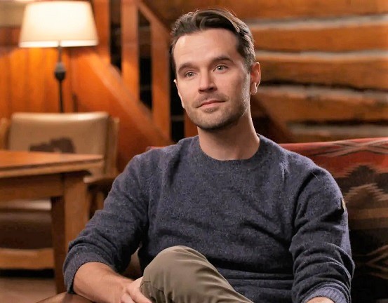Actor Graham Wardle sitting down on a sofa during an interview