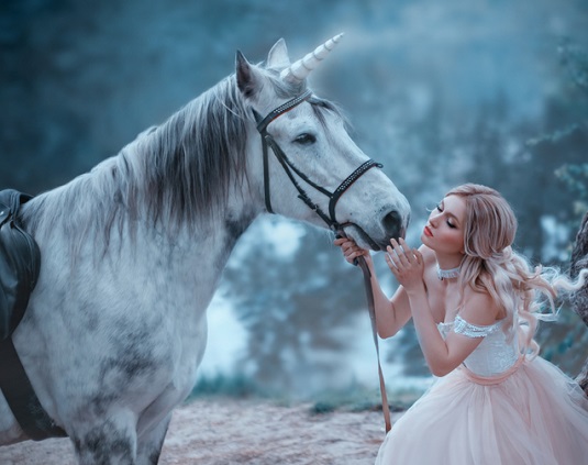 Princess kissing a unicorn in a magical forest