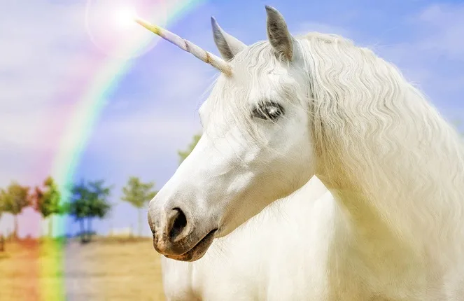 Realistic unicorn with a rainbow in the background