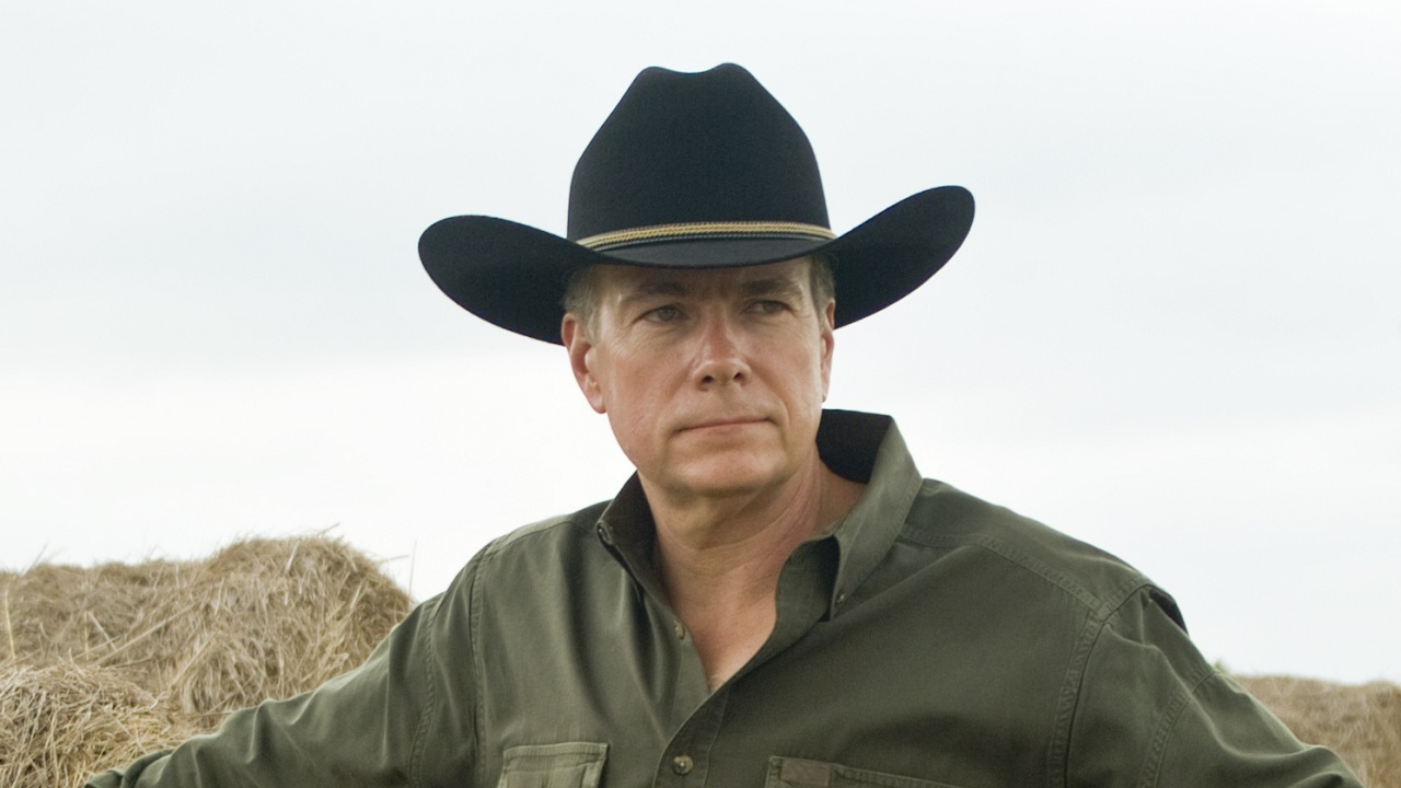 Close up of a man wearing a cowboy hat