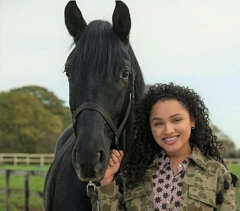 Actor Jaylon Barron holding her horse Raven from Free Rein