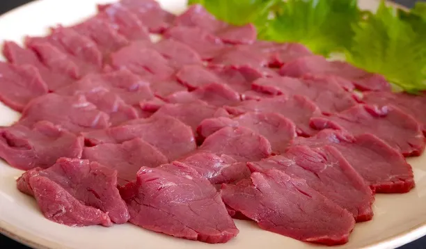 Slices of raw horse meat on a plate