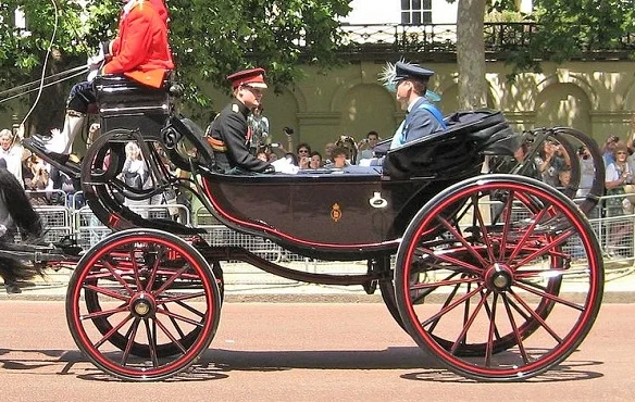 Barouche horse drawn carriage carrying Prince William and Prince Harry