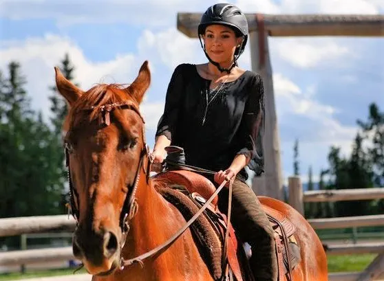Madison Cheeatow riding a horse on Heartland