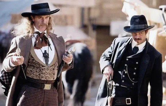 Two characters holding guns in the Deadwood western TV show