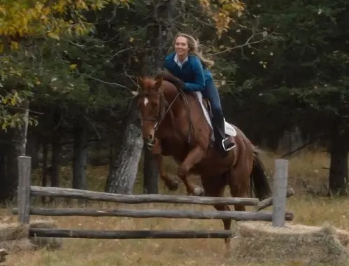 Amy Fleming jumping her horse over a fence