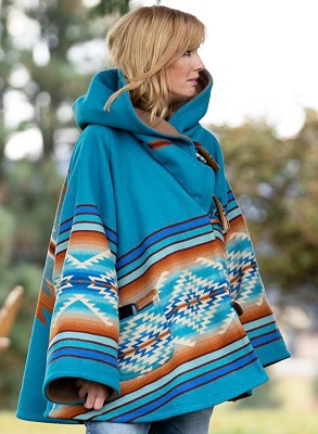 Beth Dutton wearing a blue aztec poncho in Yellowstone