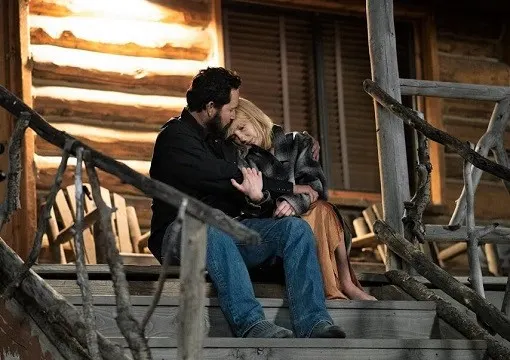 Rip Wheeler and Beth Dutton hugging on the steps outside Rip's cabin