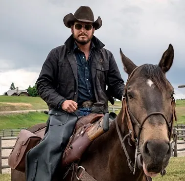 Rip Wheeler riding a horse behind-the-scenes of Yellowstone