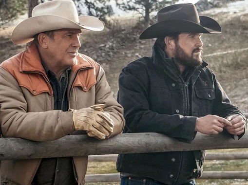 John Dutton and Rip Wheeler leaning on a fence in the Yellowstone TV series