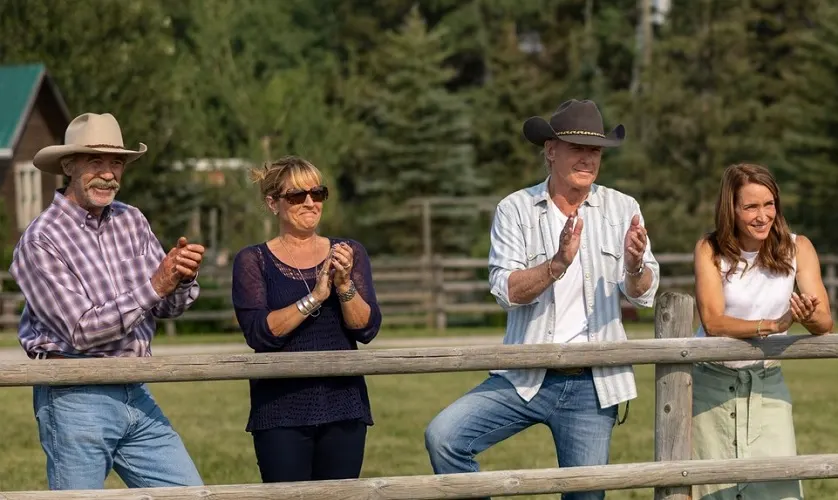 Four characters clapping including Jack Bartlett and Tim Fleming in Heartland season 16