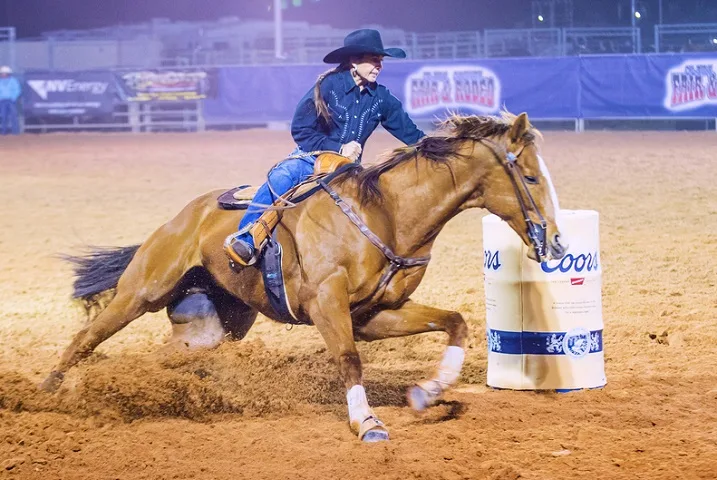 Cowgirl Participating in a Barrel racing competition