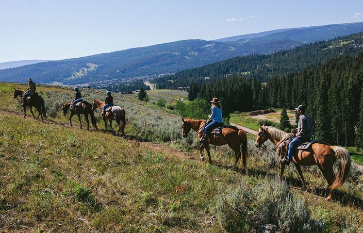 Tour group horseback riding at Lone Mountain Ranch in Montana