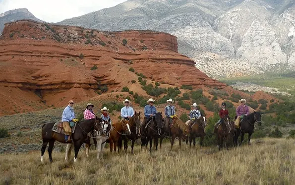 Guests out on a hrose trail ride at The Hideout Lodge & Guest Ranch in Wyoming