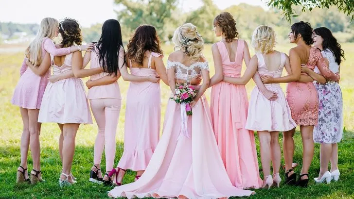 Bride and guests wearing western dresses with their backs turned to the camera